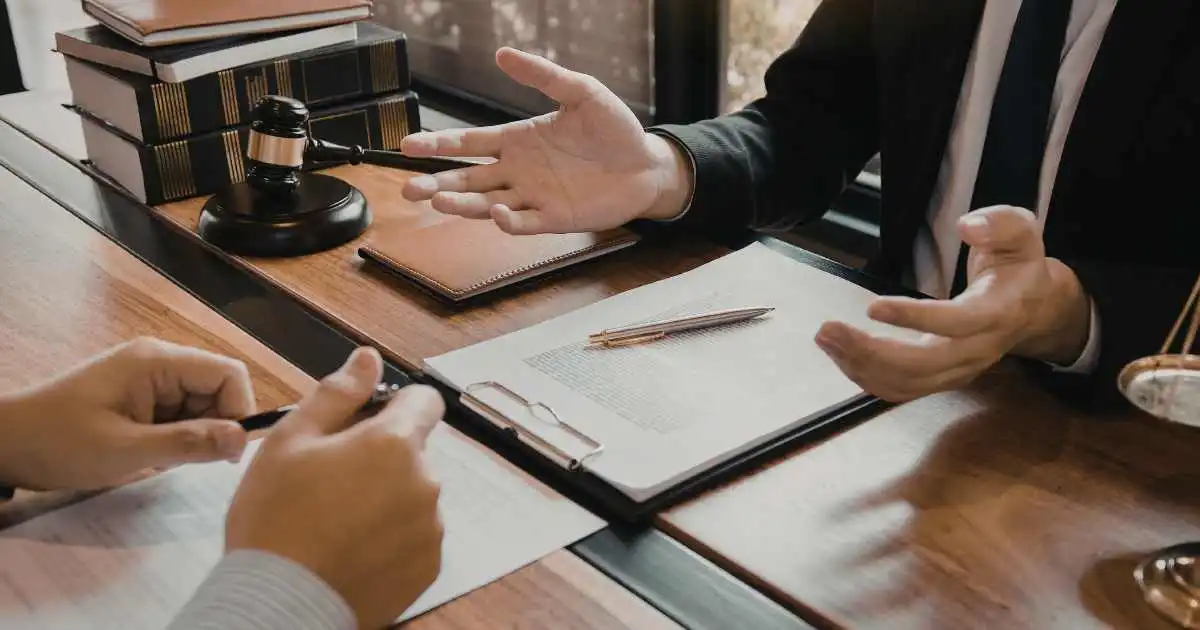 person sitting at a lawyer’s desk discussing a dwi charge and legal options